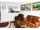 Cozy living room with tile flooring, comfortable leather seating, and artwork that enhances the living space at 2080 Karen Ave # 21, Las Vegas, NV 89169