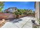 Backyard features a privacy wall, desert landscaping, palm trees and a cement patio at 2180 Maple Shade St, Henderson, NV 89002