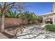 Yard featuring desert landscaping, privacy walls, a partially covered patio, and an outdoor hot tub at 2180 Maple Shade St, Henderson, NV 89002
