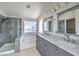 Stylish bathroom features a double vanity, a soaking tub, and a glass shower at 2180 Maple Shade St, Henderson, NV 89002