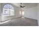 Bright bedroom with high ceilings, a ceiling fan, and a large window at 2180 Maple Shade St, Henderson, NV 89002