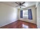 A bedroom features a ceiling fan, window with drapes, and hardwood floors at 2180 Maple Shade St, Henderson, NV 89002