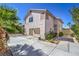 Beautiful exterior of a two-story home with a patio, palm trees and a paved driveway at 2180 Maple Shade St, Henderson, NV 89002