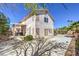 View of home exterior, back patio, privacy fencing, lush landscaping, and blue skies above at 2180 Maple Shade St, Henderson, NV 89002