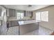 Charming kitchen with an island, stylish gray cabinets, and stainless steel appliances at 2180 Maple Shade St, Henderson, NV 89002