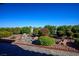 Landscaped backyard showcasing desert flora and a charming stone water feature at 2720 Spalding Dr, Las Vegas, NV 89134