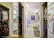 Hallway view to bright bathroom featuring double vanity, soaking tub, and walk in closet at 2720 Spalding Dr, Las Vegas, NV 89134