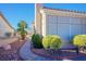 Beautifully landscaped exterior with manicured bushes and a stone pathway at 2720 Spalding Dr, Las Vegas, NV 89134