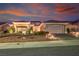 Attractive front exterior view of a single-story home featuring desert landscaping and warm lighting at 2720 Spalding Dr, Las Vegas, NV 89134