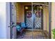 Entrance featuring decorative door with colorful wreaths, bench and 