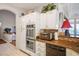 Modern kitchen featuring stainless steel appliances, white cabinets, and tile backsplash at 2720 Spalding Dr, Las Vegas, NV 89134