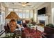Inviting living room with a cozy fireplace, large windows, and comfortable leather seating at 2720 Spalding Dr, Las Vegas, NV 89134