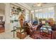 Comfortable living room featuring a built-in bookcase, plantation shutters, and classic decor at 2720 Spalding Dr, Las Vegas, NV 89134