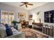 Inviting living room with desk, comfortable couch, area rug and a ceiling fan at 2720 Spalding Dr, Las Vegas, NV 89134