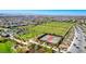 Beautiful community aerial view showcasing lush green soccer fields and tennis courts at 3049 Echoed Rondel Ln, Henderson, NV 89044