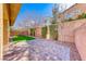 Private brick patio perfect for outdoor relaxation or entertaining with manicured landscaping at 3049 Echoed Rondel Ln, Henderson, NV 89044