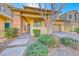 Charming home featuring a landscaped front yard, brick accents, and a welcoming front porch at 3049 Echoed Rondel Ln, Henderson, NV 89044