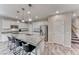 Modern kitchen boasts a granite island, stainless appliances, and sleek white cabinets at 3049 Echoed Rondel Ln, Henderson, NV 89044