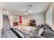 Cozy living room with a large sectional sofa, a ceiling fan, and staircase at 3049 Echoed Rondel Ln, Henderson, NV 89044
