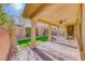 Covered patio with brick flooring and manicured backyard at 3049 Echoed Rondel Ln, Henderson, NV 89044