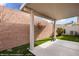 Covered back patio area with artificial turf and brick walls for privacy at 344 Tuscany Cir, Mesquite, NV 89027