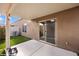 Covered back patio area with artificial turf and a sliding glass door into the home at 344 Tuscany Cir, Mesquite, NV 89027