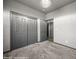 Neutral bedroom featuring plush carpet, gray trim, closet with sliding doors, and modern light fixture at 344 Tuscany Cir, Mesquite, NV 89027