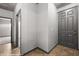 View of a hallway featuring a grey front door, tile floors, and neutral paint at 344 Tuscany Cir, Mesquite, NV 89027