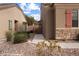 A view of the side of the house showing the yard and stone detailing at 344 Tuscany Cir, Mesquite, NV 89027