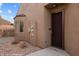 Exterior view of a front entrance with a dark wood door and beige stucco at 344 Tuscany Cir, Mesquite, NV 89027