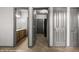 Hallway with wood-look flooring and doors leading to a bathroom and other rooms at 344 Tuscany Cir, Mesquite, NV 89027