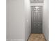 View of a light, bright hallway featuring tile floors and a gray, paneled front door at 344 Tuscany Cir, Mesquite, NV 89027
