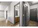Hallway with tile floors, neutral paint, and view to the bathroom with wood vanity at 344 Tuscany Cir, Mesquite, NV 89027