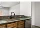 Kitchen sink with stainless steel dishwasher, green countertops, and wood cabinets at 344 Tuscany Cir, Mesquite, NV 89027