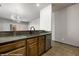 View of the open kitchen with green countertops, stainless steel dishwasher, sink and faucet at 344 Tuscany Cir, Mesquite, NV 89027