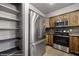 Bright kitchen features stainless steel appliances, wood cabinets, and a walk in pantry at 344 Tuscany Cir, Mesquite, NV 89027