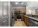 View of a kitchen featuring stainless appliances, wood cabinets, and stone countertops at 344 Tuscany Cir, Mesquite, NV 89027