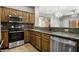 View of a kitchen featuring stainless appliances, wood cabinets, and stone countertops at 344 Tuscany Cir, Mesquite, NV 89027
