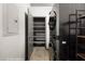 The laundry room boasts a stacked washer/dryer, shelves and a utility closet at 344 Tuscany Cir, Mesquite, NV 89027