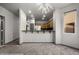 Living room featuring an open kitchen, carpet flooring, and a modern light fixture at 344 Tuscany Cir, Mesquite, NV 89027