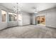 Living room with sliding glass doors, carpet flooring, and modern light fixture at 344 Tuscany Cir, Mesquite, NV 89027