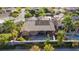 This home's backyard features a pool and patio, enhanced by mature palm trees at 3615 Hardwick Hall Way, Las Vegas, NV 89135