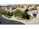 A home showcasing a well-maintained yard with mature trees, nestled in a peaceful community setting at 3615 Hardwick Hall Way, Las Vegas, NV 89135