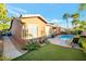 Well-maintained backyard with a pool, patio, and lush landscaping, ideal for relaxation and entertaining at 3615 Hardwick Hall Way, Las Vegas, NV 89135