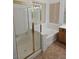 Bright bathroom featuring shower, soaking tub, and window for natural light at 3615 Hardwick Hall Way, Las Vegas, NV 89135