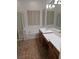 Bright bathroom featuring shower, soaking tub, double sinks and large mirror at 3615 Hardwick Hall Way, Las Vegas, NV 89135