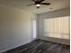 Bright bedroom featuring dark wood floors and a door leading to outdoor space at 3615 Hardwick Hall Way, Las Vegas, NV 89135