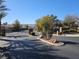 Community entrance with landscaped median and secure gates at 3615 Hardwick Hall Way, Las Vegas, NV 89135