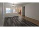 Bright dining room with wood floors, arched doorway, and elegant chandelier at 3615 Hardwick Hall Way, Las Vegas, NV 89135