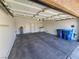 Spacious garage with ample storage space and blue recycling bins at 3615 Hardwick Hall Way, Las Vegas, NV 89135
